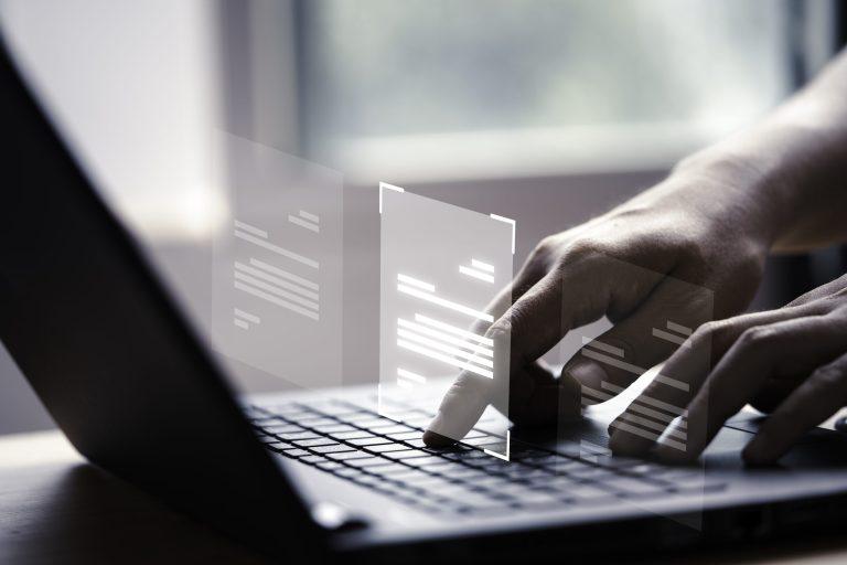 hand-using-laptop-computer-with-virtual-screen-document-online-approve-paperless-quality-assurance-erp-management-concept-scaled-1